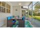 Relaxing screened porch with dining set and view of the backyard at 1243 Siesta Bayside Dr # D, Sarasota, FL 34242