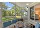 Enjoy a relaxing screened porch with seating area and view of lush greenery at 1243 Siesta Bayside Dr # D, Sarasota, FL 34242