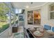 Enjoy waterfront views from this screened porch, complete with dining set at 1243 Siesta Bayside Dr # D, Sarasota, FL 34242