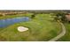 Aerial view of a lush golf course with a lake at 12826 Del Corso Loop, Lakewood Ranch, FL 34211