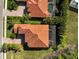 An aerial view showcases red-tiled roofs and meticulously maintained lush landscaping at 13408 Swiftwater Way, Bradenton, FL 34211
