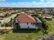 A sprawling residence with a red-tiled roof and screened-in pool encloses the backyard at 13408 Swiftwater Way, Bradenton, FL 34211