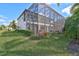 Spacious backyard features an extended screened-in lanai and manicured lawn at 13408 Swiftwater Way, Bradenton, FL 34211