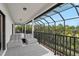 Covered balcony with comfortable seating and views of lush greenery at 13408 Swiftwater Way, Bradenton, FL 34211