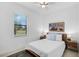 Cozy bedroom with a comfortable bed, natural light, and hardwood floors at 13408 Swiftwater Way, Bradenton, FL 34211