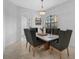 Formal dining room with stylish table, chairs, chandelier, and plenty of natural light at 13408 Swiftwater Way, Bradenton, FL 34211