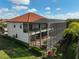 A home with an expansive screened-in lanai and balconies is surrounded by green lawns at 13408 Swiftwater Way, Bradenton, FL 34211