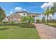 Beautiful two-story home with brick driveway, manicured landscaping, and stone accents at 13408 Swiftwater Way, Bradenton, FL 34211