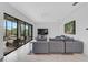 Spacious living room featuring sliding glass doors and a comfortable gray sectional couch at 13408 Swiftwater Way, Bradenton, FL 34211