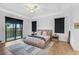 Airy main bedroom showcasing wood floors, a balcony, and minimalist decor at 13408 Swiftwater Way, Bradenton, FL 34211