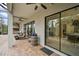 Covered patio with an outdoor kitchen, ceiling fans, and sliding glass doors at 13408 Swiftwater Way, Bradenton, FL 34211