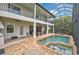 Rear view of the home shows balconies, the patio, pool and spa area at 13408 Swiftwater Way, Bradenton, FL 34211