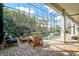 View of a screened in pool with a sun shelf, spa, and seating at 13408 Swiftwater Way, Bradenton, FL 34211