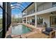 A screened pool and patio area with an outdoor grill at 13408 Swiftwater Way, Bradenton, FL 34211