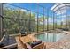 A beautiful screened pool with spa and outdoor seating at 13408 Swiftwater Way, Bradenton, FL 34211