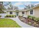 Bright yellow house with white trim, landscaping, and walkway at 13623 2Nd E Ave, Bradenton, FL 34212