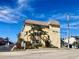 Exterior view of Gulf n Bay condos, showing building and landscaping at 1400 Tarpon Center Dr # 218, Venice, FL 34285