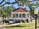 White gazebo with red tile roof, benches and landscaping at 1400 Tarpon Center Dr # 218, Venice, FL 34285