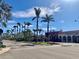 Palm-tree lined street with shops and clear blue skies at 1400 Tarpon Center Dr # 218, Venice, FL 34285