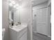 Simple bathroom with white vanity and built-in linen closet at 15026 Dania Ave, Port Charlotte, FL 33953