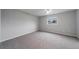 Bright bedroom with grey carpet and ceiling fan at 15026 Dania Ave, Port Charlotte, FL 33953