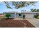 A light blue house with a two-car garage and stone accents at 15026 Dania Ave, Port Charlotte, FL 33953