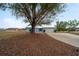 Light blue house with attached garage and mature landscaping at 15026 Dania Ave, Port Charlotte, FL 33953