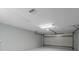 Garage with white walls, open garage door, and painted floor at 15026 Dania Ave, Port Charlotte, FL 33953