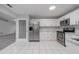 Bright kitchen with stainless steel appliances and white cabinets at 15026 Dania Ave, Port Charlotte, FL 33953