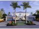 Two-story home with double garages, lush landscaping, and palm trees at 1521 S Lake Shore Dr, Sarasota, FL 34231
