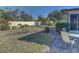 Backyard with patio, landscaping, and a partial view of the house at 1610 Cypress Point Ct, Venice, FL 34293