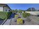 Landscaped backyard with walkway and mature shrubs at 1610 Cypress Point Ct, Venice, FL 34293