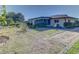 Spacious backyard with patio, landscaping, and screened enclosure at 1610 Cypress Point Ct, Venice, FL 34293