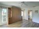 Bedroom with wood flooring, built-in murphy bed, and bathroom access at 1610 Cypress Point Ct, Venice, FL 34293