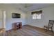 Spacious bedroom with wood flooring and a TV stand at 1610 Cypress Point Ct, Venice, FL 34293