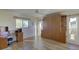 Bedroom with wood flooring, built-in murphy bed, and windows at 1610 Cypress Point Ct, Venice, FL 34293