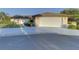House exterior featuring a white garage door and neat landscaping at 1610 Cypress Point Ct, Venice, FL 34293