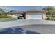 Single-story house with attached garage and driveway at 1610 Cypress Point Ct, Venice, FL 34293