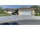 Single-story house with attached garage and landscaped yard at 1610 Cypress Point Ct, Venice, FL 34293