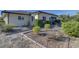 Landscaped side yard with walkway and mature shrubs at 1610 Cypress Point Ct, Venice, FL 34293