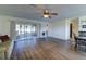 Living room with hardwood floors, sliding doors, and a ceiling fan at 1610 Cypress Point Ct, Venice, FL 34293