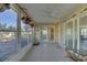 Sunroom with tiled floor, sliding glass doors, and access to kitchen at 1610 Cypress Point Ct, Venice, FL 34293