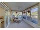 Relaxing sunroom with tiled floor and wicker furniture at 1610 Cypress Point Ct, Venice, FL 34293