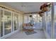Relaxing sunroom with tiled floor and wicker furniture at 1610 Cypress Point Ct, Venice, FL 34293