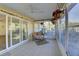 Bright sunroom with tiled floor, wicker furniture, and sliding glass doors at 1610 Cypress Point Ct, Venice, FL 34293