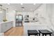 Modern kitchen with white cabinets, stainless steel appliances, and quartz countertops at 1703 N Tamiami Trl # 209, Sarasota, FL 34234