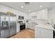 Modern kitchen with white cabinets and stainless steel appliances at 1703 N Tamiami Trl # 209, Sarasota, FL 34234