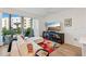 Living room with sectional sofa, large TV and access to a balcony at 1703 N Tamiami Trl # 209, Sarasota, FL 34234