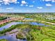 Community overview featuring lakefront homes and lush landscaping at 20686 Valprato Ct, Venice, FL 34293