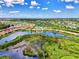 An aerial view of a lakefront home and neighborhood at 20686 Valprato Ct, Venice, FL 34293